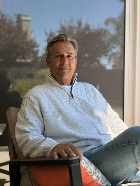 Peter seated comfortably in a bright room